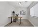 A well-lit office with neutral carpet and a dark brown desk, perfect for remote work at 305 Napa Hills Dr, Las Vegas, NV 89144