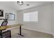 A well-lit office with neutral carpet and a dark brown desk, perfect for remote work at 305 Napa Hills Dr, Las Vegas, NV 89144