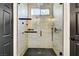 Modern frameless shower with hexagon tile flooring, overhead rainfall shower head, and gray accent tiles at 305 Napa Hills Dr, Las Vegas, NV 89144