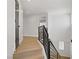 Staircase with metal railing and light wood floors with an exterior door leading to other rooms at 305 Napa Hills Dr, Las Vegas, NV 89144