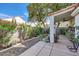 Serene backyard with lush greenery, rock features, and a covered patio perfect for relaxation and outdoor enjoyment at 310 Pissarro Pl, Henderson, NV 89074