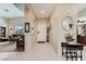 Inviting foyer with tile flooring that flows into a spacious living area, offering a bright and welcoming entrance at 310 Pissarro Pl, Henderson, NV 89074