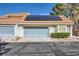 Two car garage with solar panels on the roof and well-maintained landscaping, in a desirable location at 310 Pissarro Pl, Henderson, NV 89074