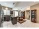 Open kitchen and dining area with stainless appliances, a center island, and a dining table at 310 Pissarro Pl, Henderson, NV 89074