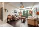 Cozy living room with hardwood floors, skylight, and an abundance of natural light and plants at 310 Pissarro Pl, Henderson, NV 89074