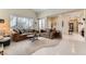 Bright and airy living room with plush sofas, large windows, and lots of natural light at 310 Pissarro Pl, Henderson, NV 89074