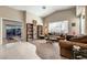 Comfortable living room with plush carpeting, a large window, and access to the backyard at 310 Pissarro Pl, Henderson, NV 89074
