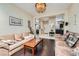 Living room featuring hardwood floors, a decorative chandelier, and views into the kitchen at 310 Pissarro Pl, Henderson, NV 89074