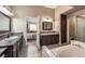 Bright bathroom features dual sinks, a soaking tub, and a separate shower, offering a spa-like experience at 310 Pissarro Pl, Henderson, NV 89074