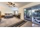 Spacious main bedroom with a fireplace, ceiling fan, and access to an outdoor patio at 310 Pissarro Pl, Henderson, NV 89074