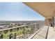 Large balcony offering city and mountain views, with a tiled floor and a potted tree for greenery at 3111 Bel Air Dr # 22B, Las Vegas, NV 89109