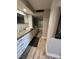 Bathroom featuring double vanity, undermount sinks, wall-mounted faucets, and a soaking tub at 3111 Bel Air Dr # 22B, Las Vegas, NV 89109
