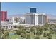Golf course view, surrounded by lush trees, against the Las Vegas hotels and cityscape at 3111 Bel Air Dr # 22B, Las Vegas, NV 89109