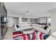 Spacious living room featuring a modern sofa, unique coffee table, and open flow to the kitchen and dining area at 3111 Bel Air Dr # 22B, Las Vegas, NV 89109