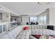 Open-concept living area featuring an oversized sofa, modern decor, and access to city view balcony at 3111 Bel Air Dr # 22B, Las Vegas, NV 89109