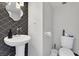 Stylish powder room with unique mirror and pedestal sink at 3111 Bel Air Dr # 22B, Las Vegas, NV 89109