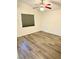 Bright bedroom with plank flooring, ceiling fan, and window with blinds for privacy at 3665 Lucky Horseshoe Ct, Las Vegas, NV 89129