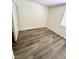 Cozy bedroom with wood-look flooring, a window providing natural light, and a closet for storage at 3665 Lucky Horseshoe Ct, Las Vegas, NV 89129