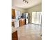 Functional kitchen with light wood cabinets, white appliances, and a tiled backsplash, with access to the patio at 3665 Lucky Horseshoe Ct, Las Vegas, NV 89129