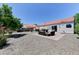 Spacious backyard features gravel landscaping, tiled patio, and outdoor seating area, perfect for entertaining at 3823 Aspen Creek Ave, North Las Vegas, NV 89031