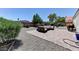 Relax in this home's backyard featuring desert landscaping and an outdoor patio seating area at 3823 Aspen Creek Ave, North Las Vegas, NV 89031
