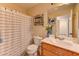 Cozy bathroom features a vanity, toilet, and shower with curtain, complete with neutral decor at 3823 Aspen Creek Ave, North Las Vegas, NV 89031