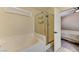 Bright bathroom featuring a tub, glass enclosed shower, and a doorway leading to the primary bedroom at 3823 Aspen Creek Ave, North Las Vegas, NV 89031