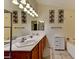 Bright bathroom featuring a double vanity, large mirrors, and stylish lighting fixtures at 3823 Aspen Creek Ave, North Las Vegas, NV 89031