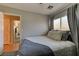 This bedroom features a neutral color palette, a large window, and a comfortable bed with soft pillows at 3823 Aspen Creek Ave, North Las Vegas, NV 89031