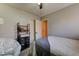 This bedroom features a neutral color scheme, a shelf, a cushioned chair, and a doorway leading to another room at 3823 Aspen Creek Ave, North Las Vegas, NV 89031