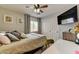Bedroom featuring a comfortable bed, ceiling fan, closet, and stylish decor at 3823 Aspen Creek Ave, North Las Vegas, NV 89031