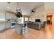 Open living space with updated kitchen, a cozy seating area, and natural light from sliding glass doors at 3823 Aspen Creek Ave, North Las Vegas, NV 89031