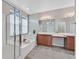 Bright bathroom featuring a large soaking tub, double sink vanity, and decorative tile flooring at 4020 Recktenwall Ave, North Las Vegas, NV 89081