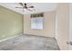 Bedroom with ceiling fan, tiled floors, and a large window at 4020 Recktenwall Ave, North Las Vegas, NV 89081