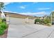 A three car garage with a wide drive way and desert landscaping at 4020 Recktenwall Ave, North Las Vegas, NV 89081