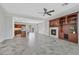 Open-concept living room featuring a fireplace, built-in shelves, and tile flooring at 4020 Recktenwall Ave, North Las Vegas, NV 89081