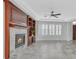 Cozy living room featuring a fireplace, built-in shelving, and bright windows at 4020 Recktenwall Ave, North Las Vegas, NV 89081