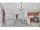 Open-concept living area with tile flooring, a fireplace, and a kitchen island at 4020 Recktenwall Ave, North Las Vegas, NV 89081