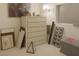 Bedroom decoration featuring a white dresser, butterfly wall art, pictures and an art pyramid at 4178 Matterhorn Way, Las Vegas, NV 89124