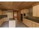 Bright kitchen featuring granite countertops, wood ceilings, and stainless steel appliances at 4178 Matterhorn Way, Las Vegas, NV 89124