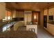 An open kitchen featuring granite countertops, wood ceilings, and stainless steel appliances at 4178 Matterhorn Way, Las Vegas, NV 89124