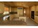 An open kitchen featuring granite countertops, wood ceilings, and stainless steel appliances at 4178 Matterhorn Way, Las Vegas, NV 89124