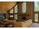 Spacious living room with wood accents, stone fireplace, modern lighting, and a large comfortable seating area at 4178 Matterhorn Way, Las Vegas, NV 89124