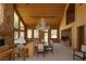 Spacious living room featuring wood paneled walls, high ceilings, a stone fireplace and many windows with natural light at 4178 Matterhorn Way, Las Vegas, NV 89124