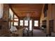 Spacious living room featuring wood paneled walls, high ceilings, a stone fireplace and many windows with natural light at 4178 Matterhorn Way, Las Vegas, NV 89124