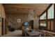 Comfortable Living room featuring wood paneled walls, natural light, and a dining area with table at 4178 Matterhorn Way, Las Vegas, NV 89124