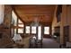 Spacious living room featuring wood paneled walls, high ceilings, a stone fireplace and many windows with natural light at 4178 Matterhorn Way, Las Vegas, NV 89124