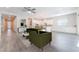 Spacious open-concept living area with an eat-in kitchen, modern lighting, and tile flooring at 421 Point Sur Ave, Las Vegas, NV 89138
