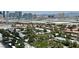 Expansive aerial view captures the city skyline beyond the green trees and neighborhood homes below at 4381 W Flamingo Rd # 2022, Las Vegas, NV 89103