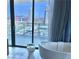 Modern bathroom featuring a soaking tub and a view of the city skyline at 4381 W Flamingo Rd # 2022, Las Vegas, NV 89103